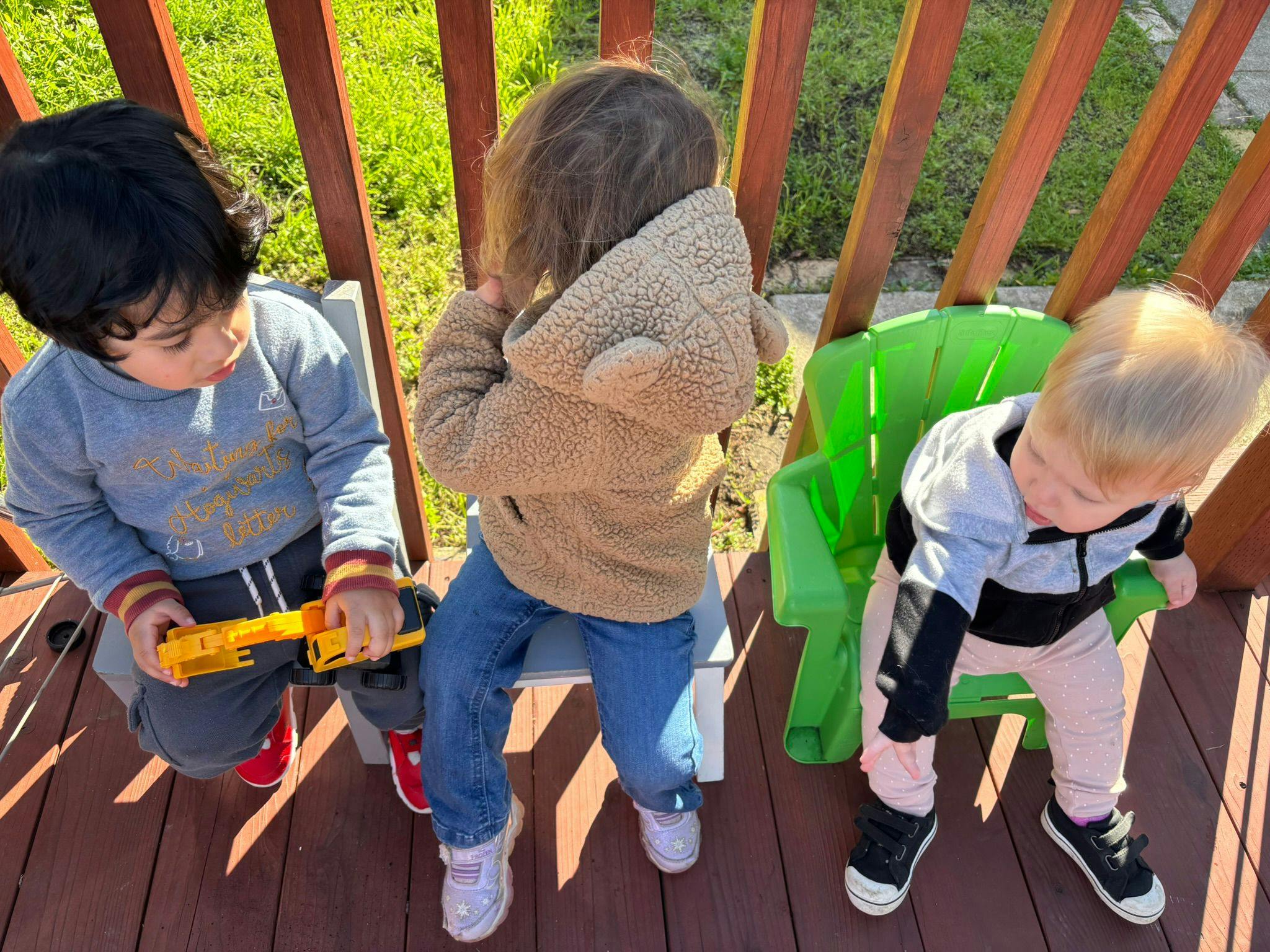 Three children playing outdoors