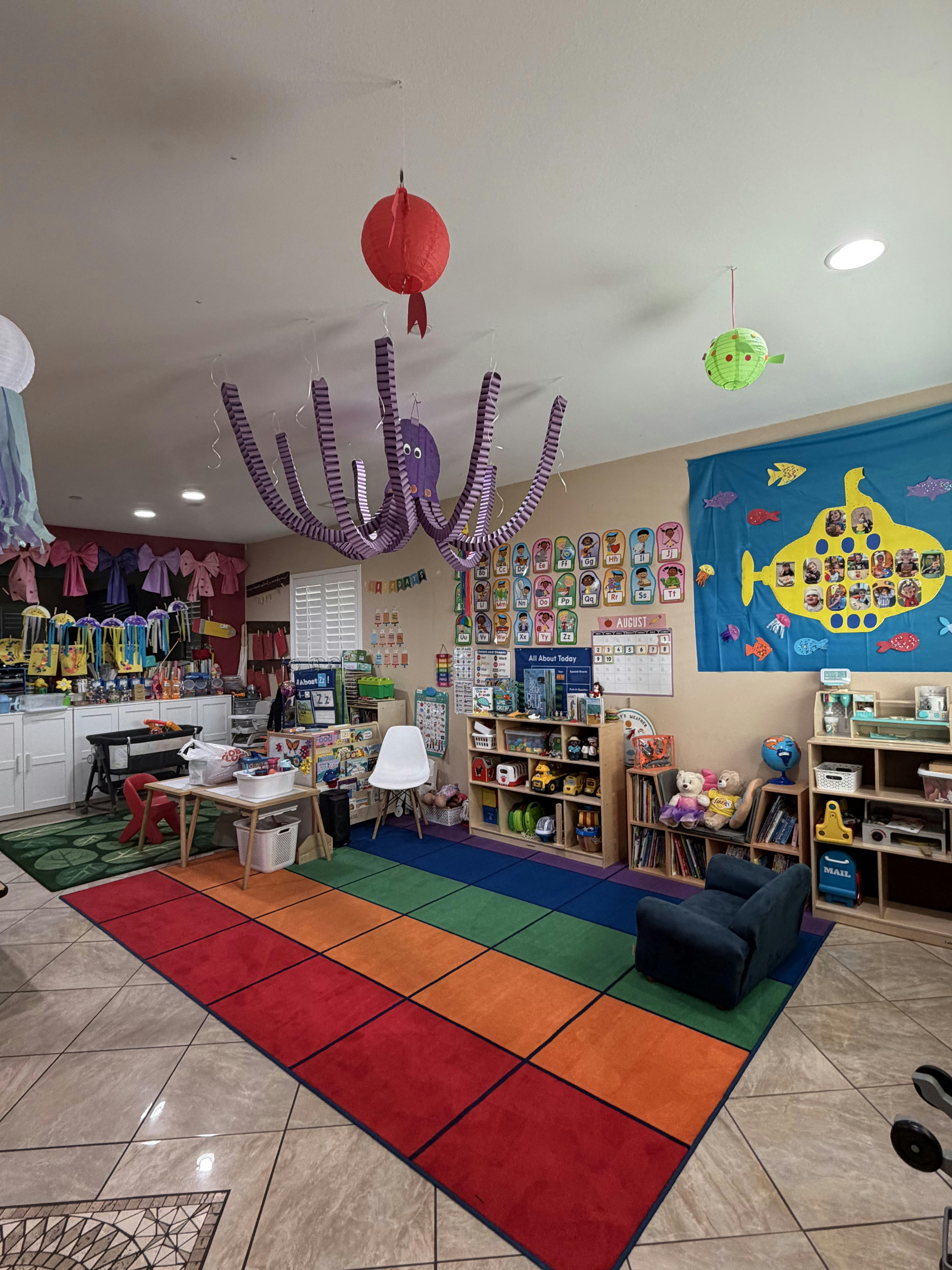 Colorful preschool classroom with children's learning materials and decor