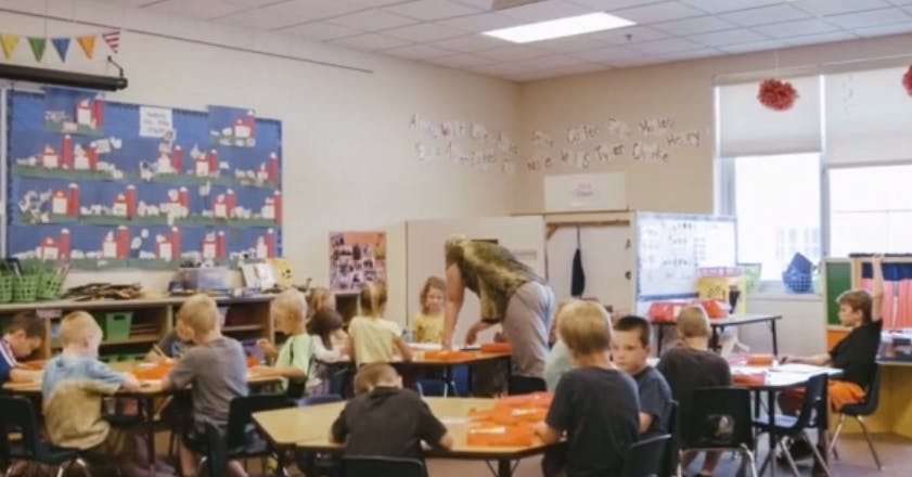 Adult and children in a classroom