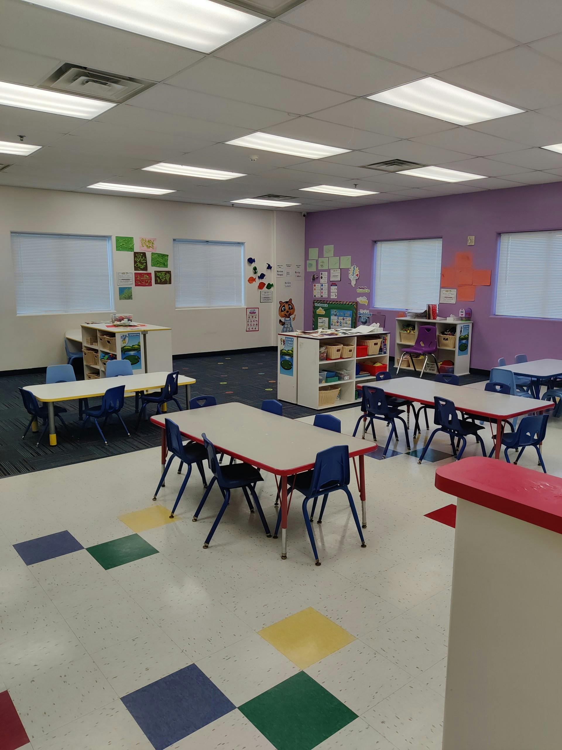 Empty classroom with small tables and chairs