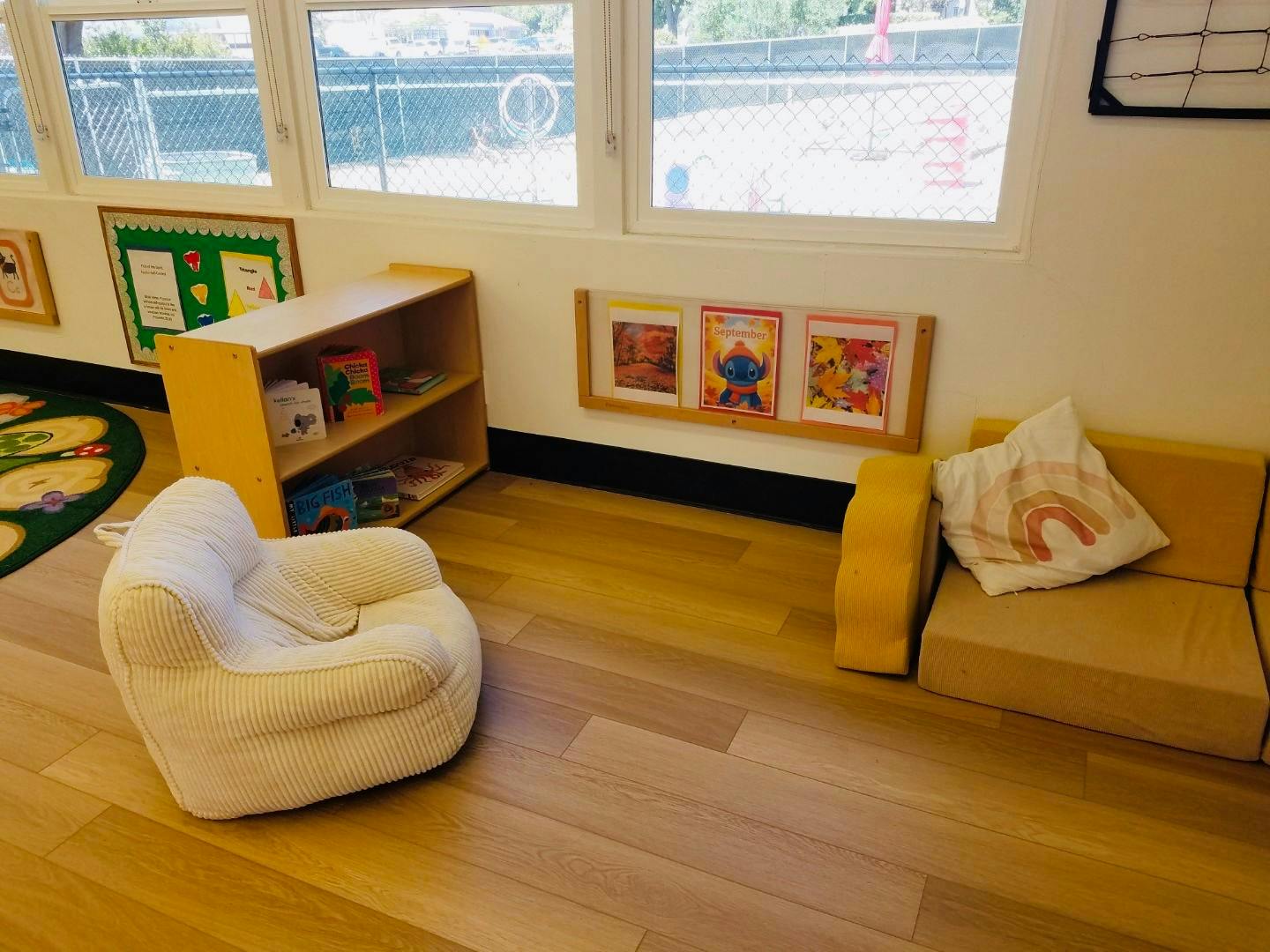 Child's armchair and sofa in a room with windows and bookshelves