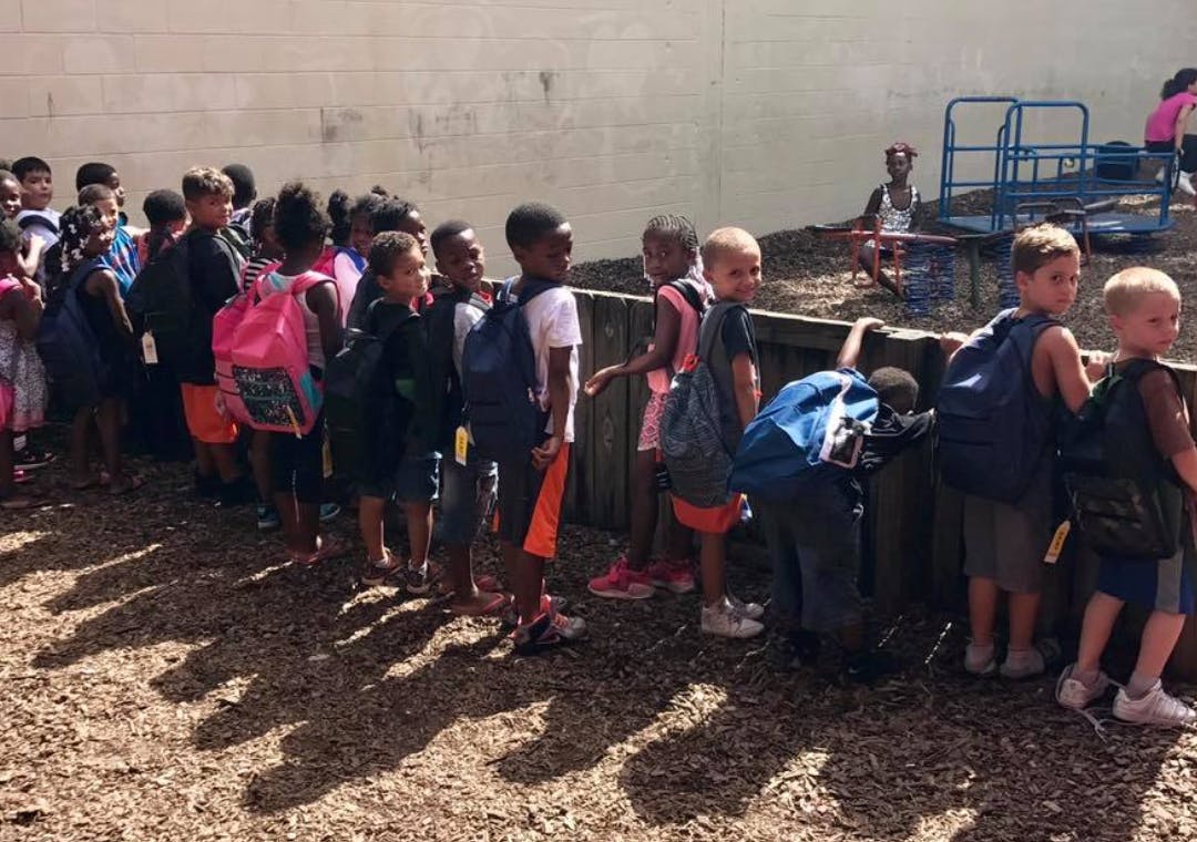 Group of children standing in a line outdoors