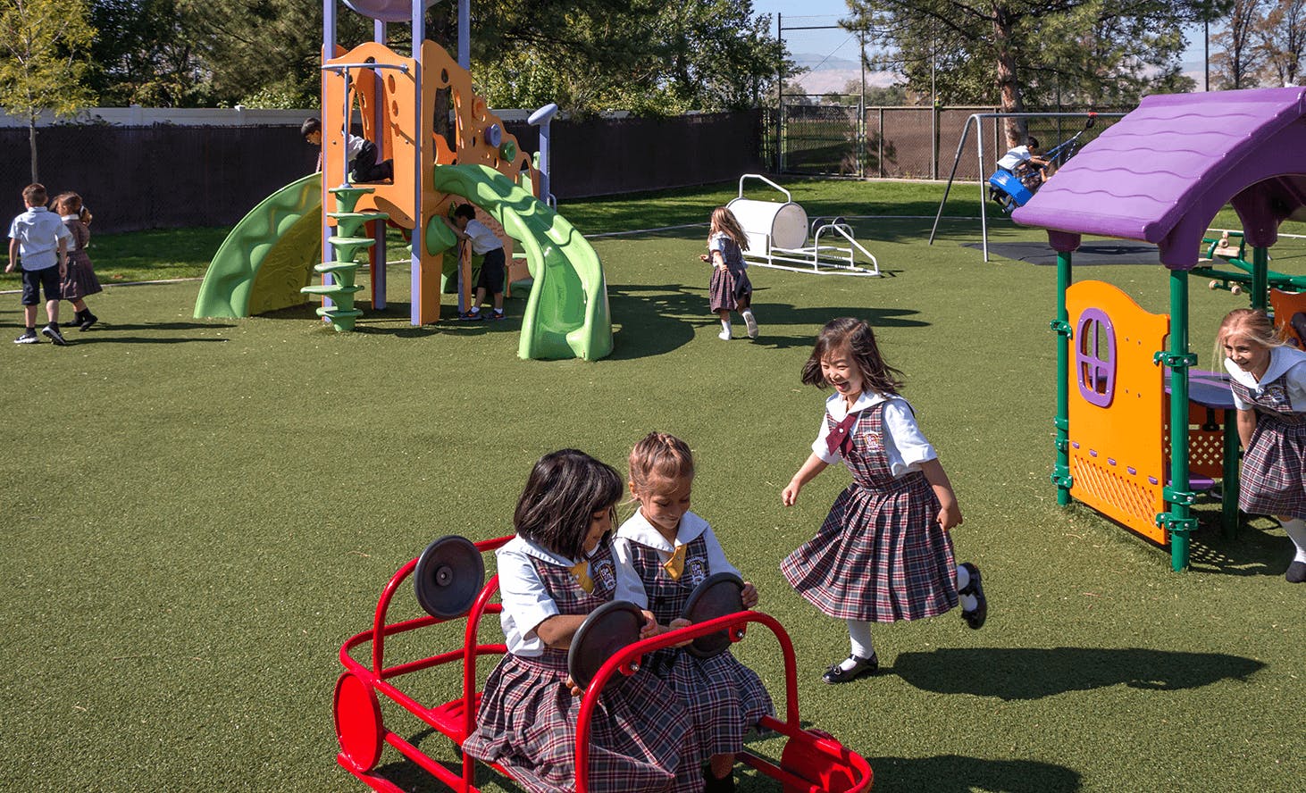 Children playing on a playground with slides and play structures