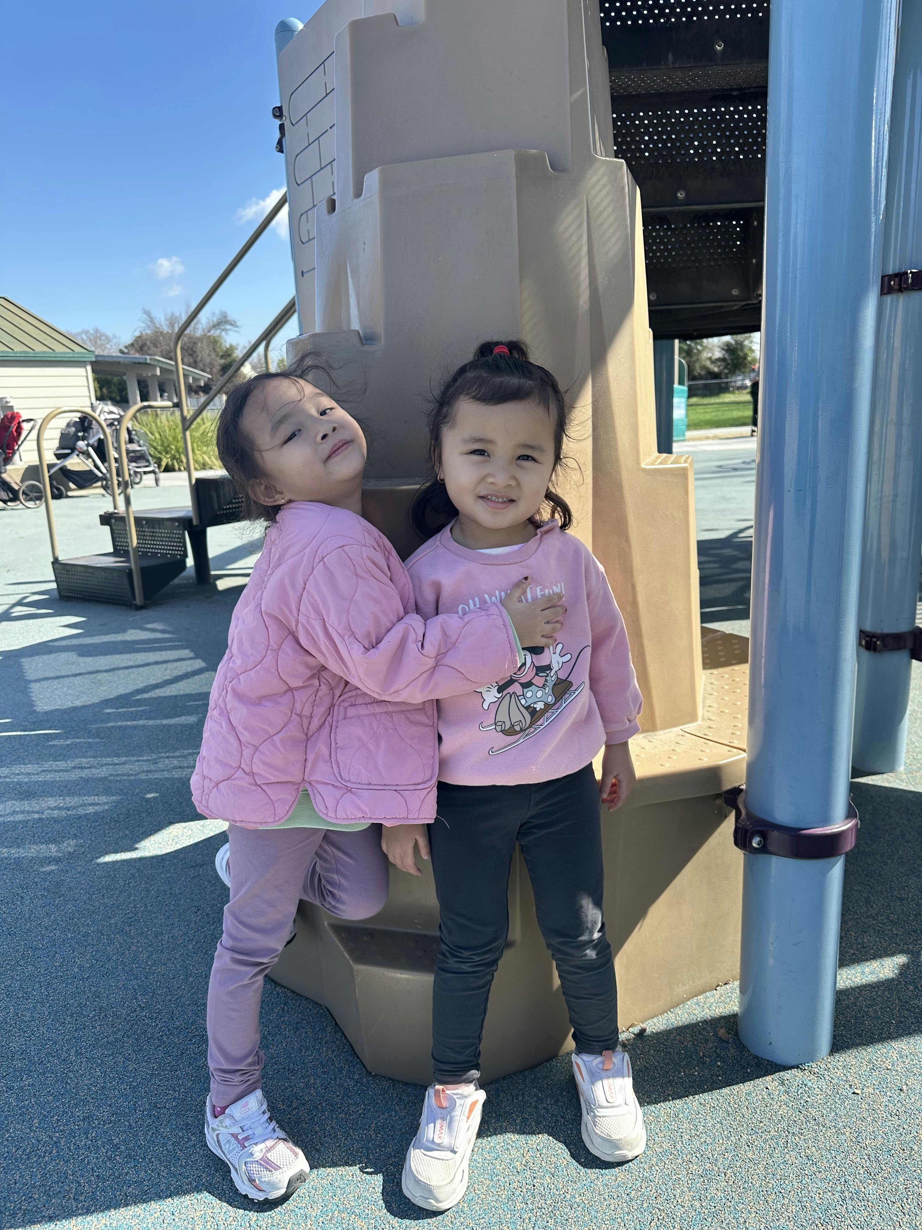 Two children standing on a playground