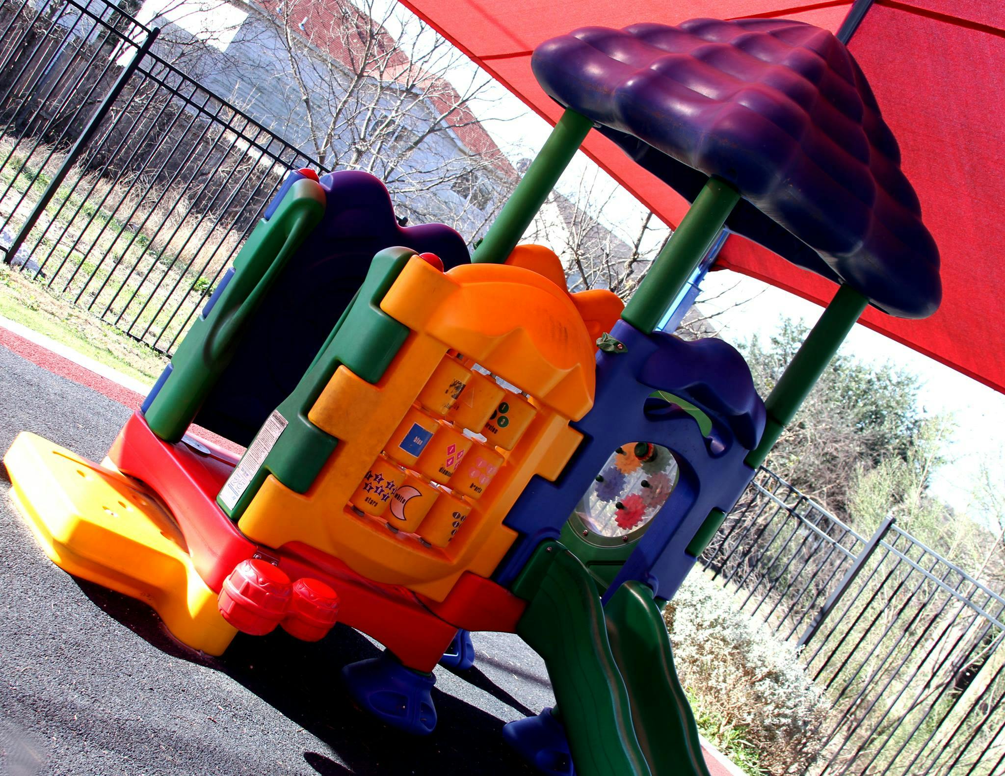Colorful playground equipment with a red canopy