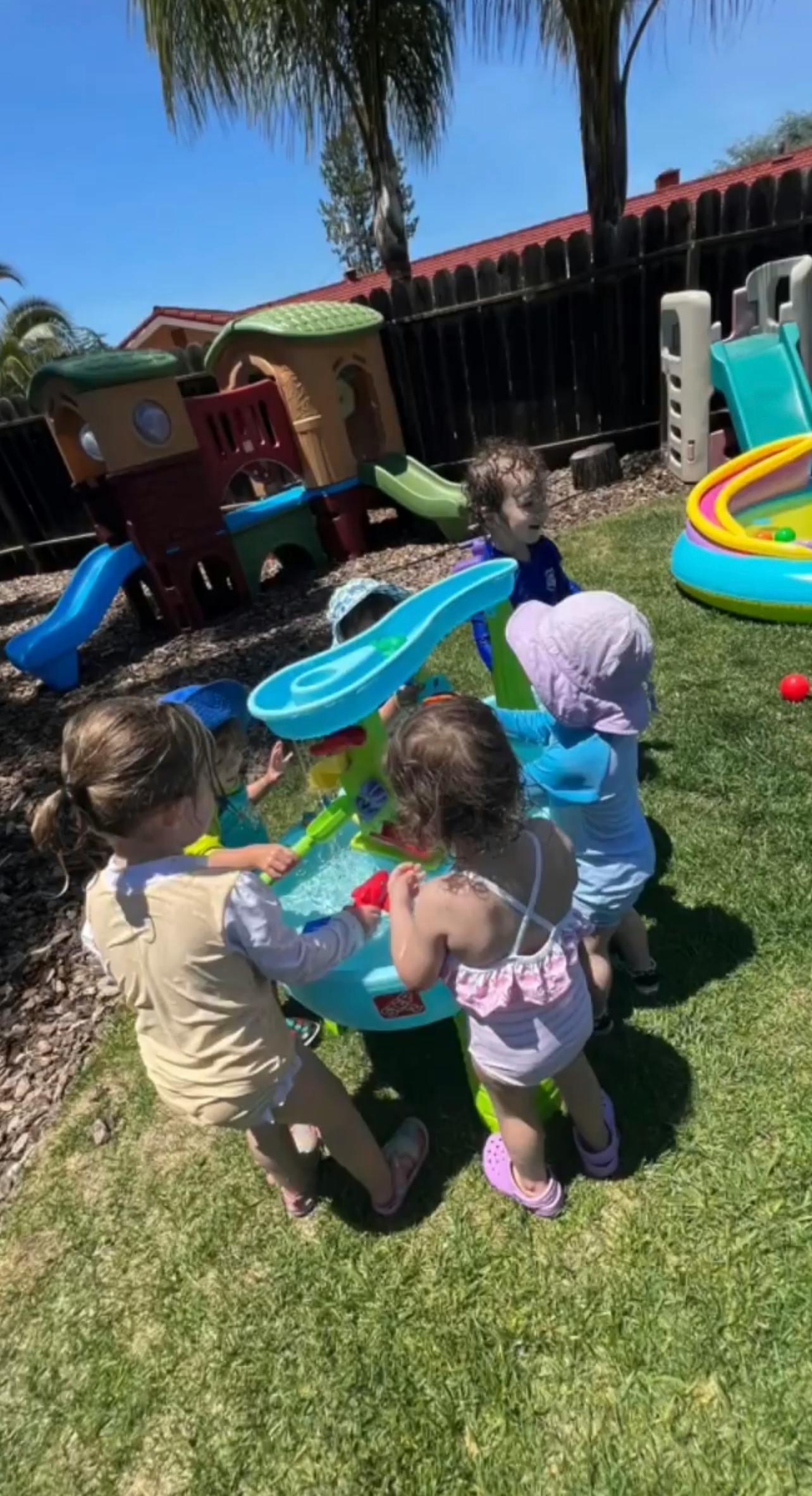 Children playing with a water table outdoors