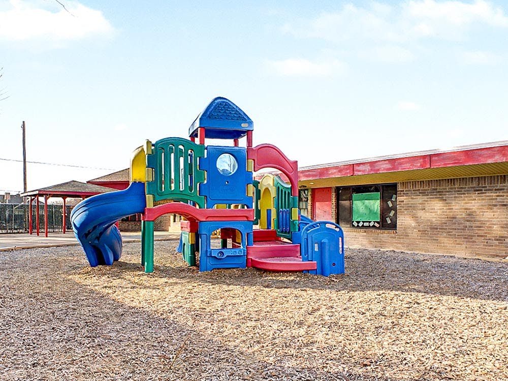 Colorful playground structure with a blue slide on wood chips