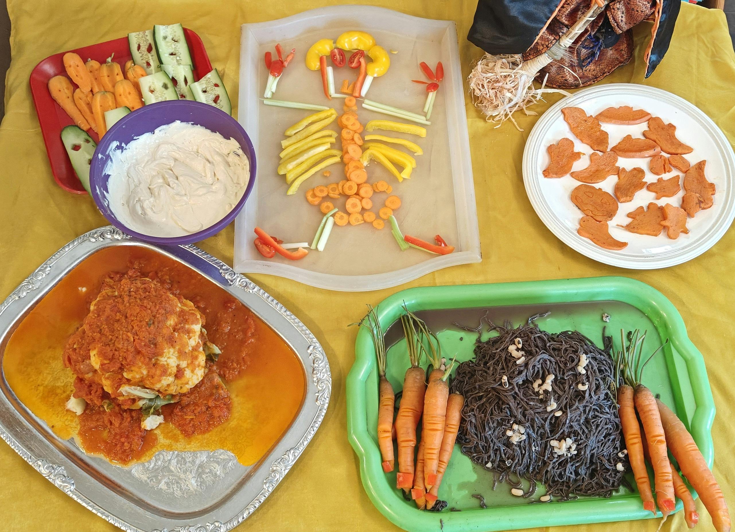 Table with various Halloween-themed food dishes