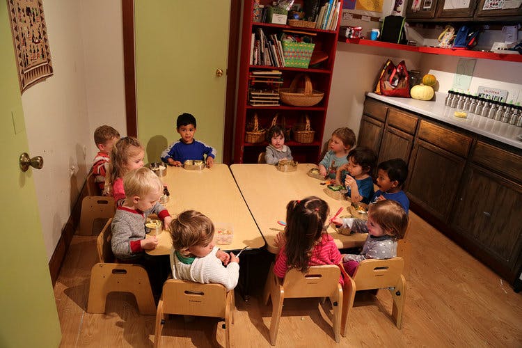 Children sitting at tables in a classroom