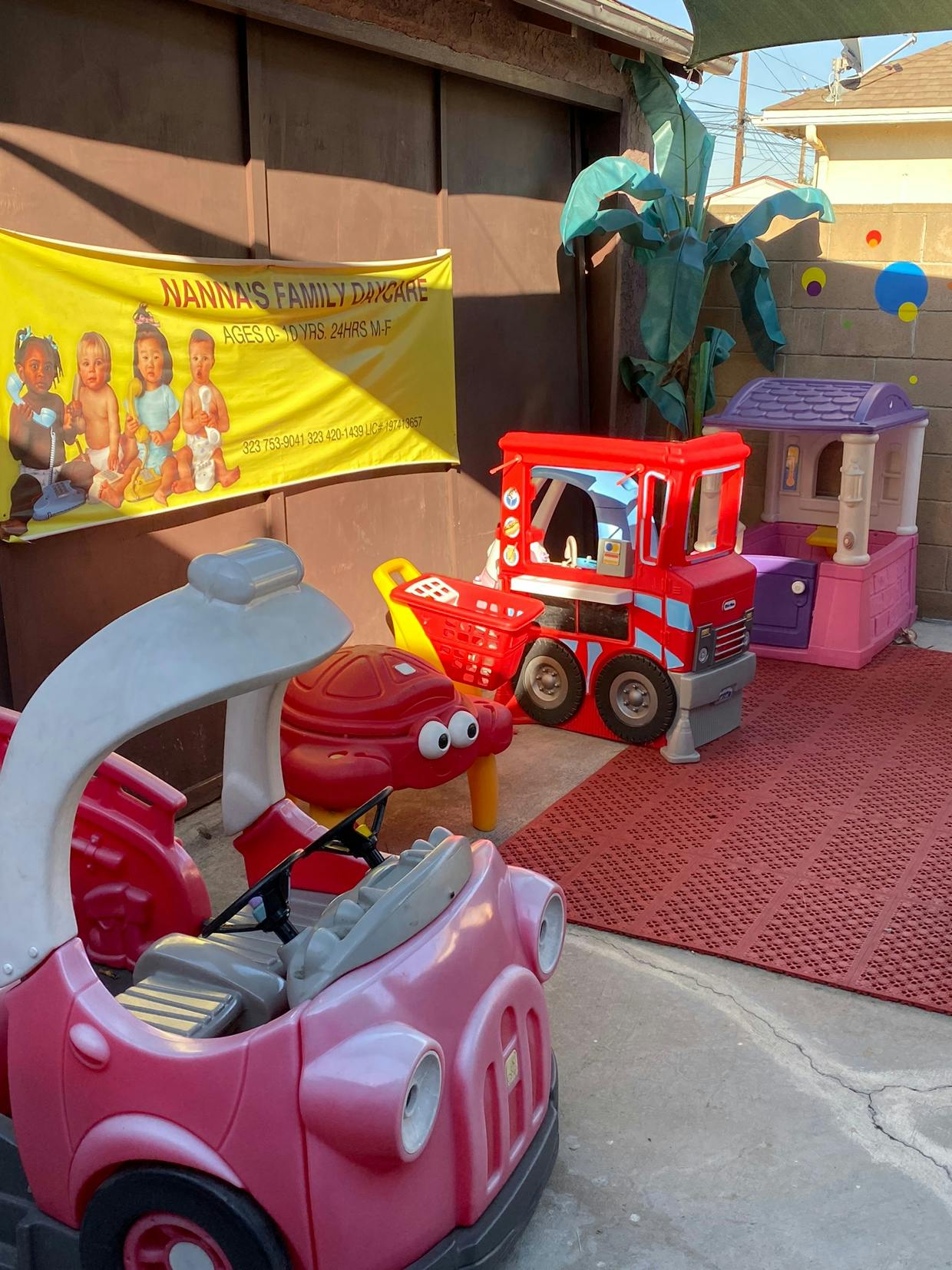 Play area with toy cars and a banner for Nanna's Family Daycare