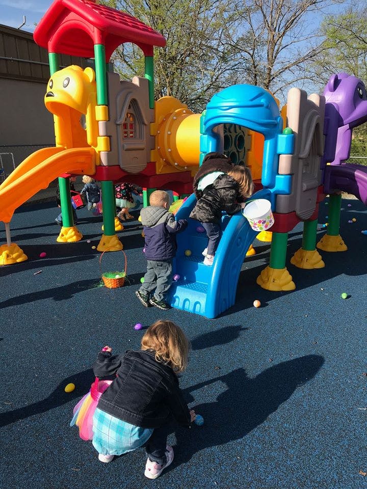 Children playing on a colorful playground structure