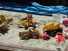 Toy construction vehicles in a sandbox