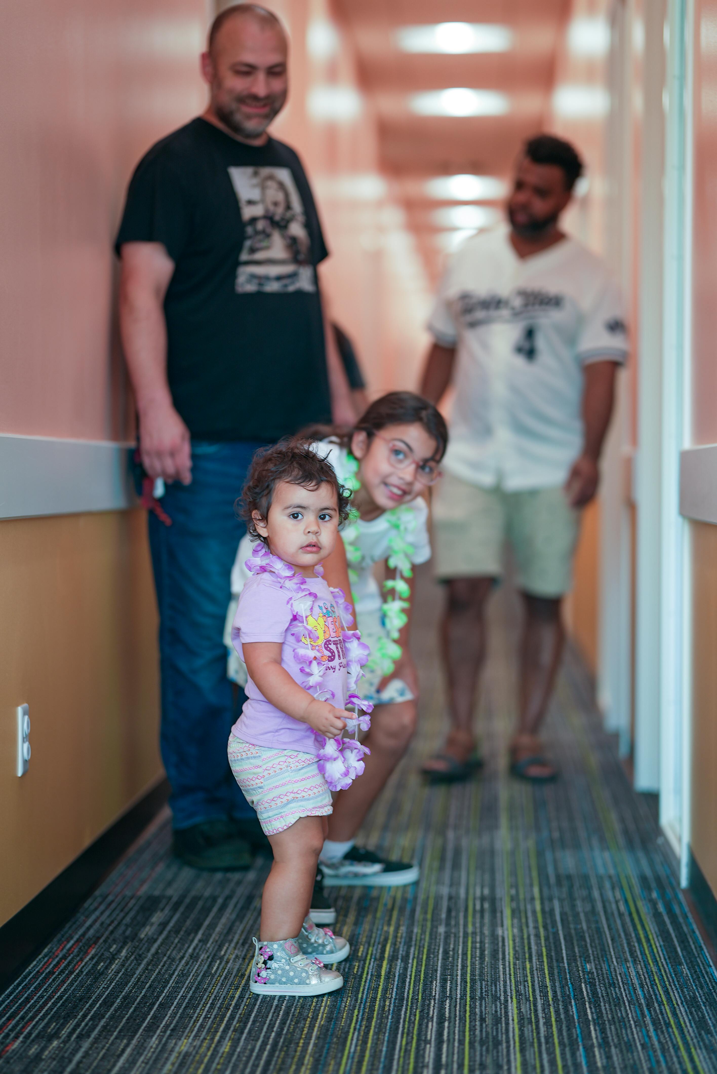 Two adults and two children in a hallway