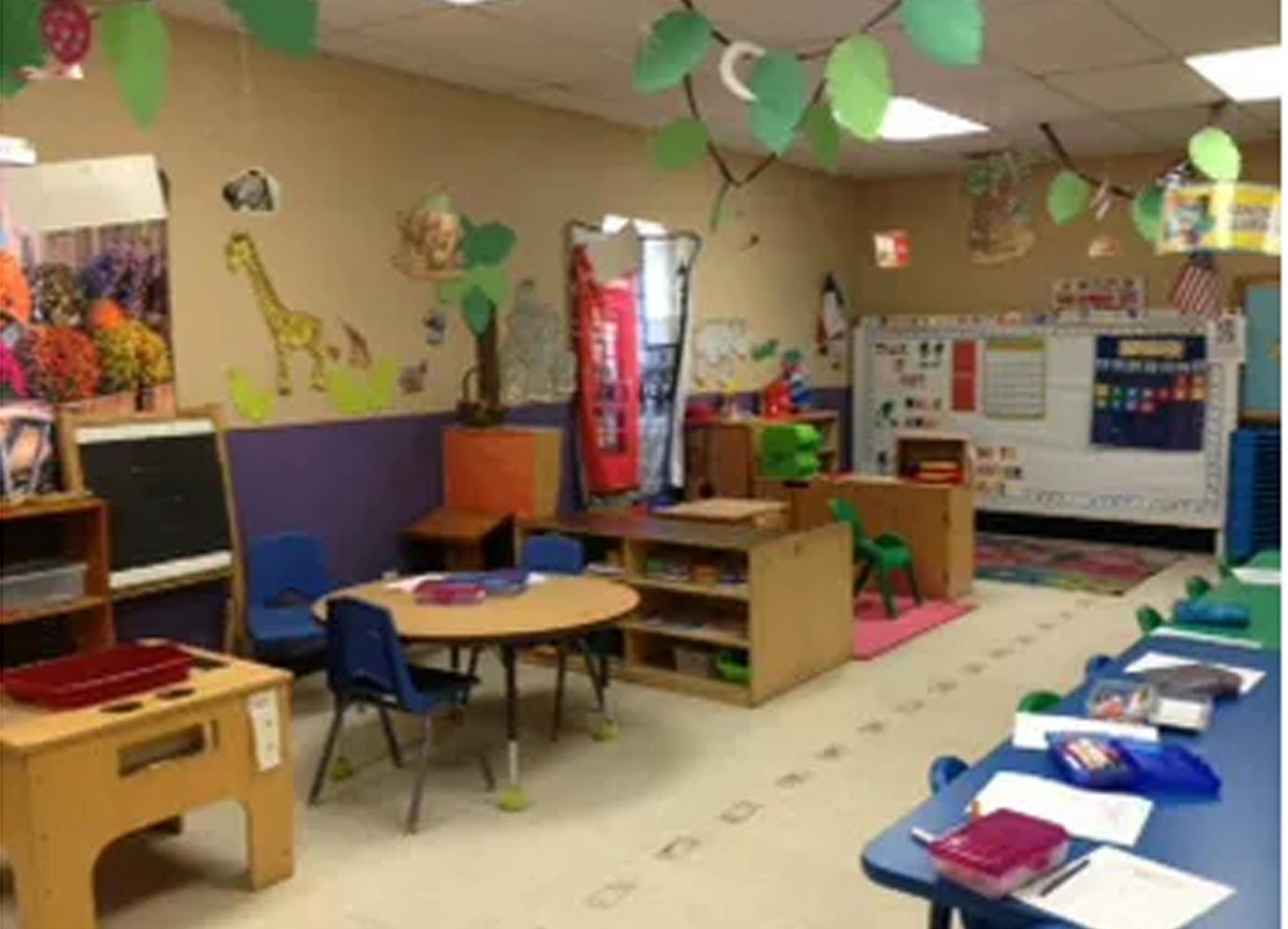 Classroom with small tables and chairs, decorated walls