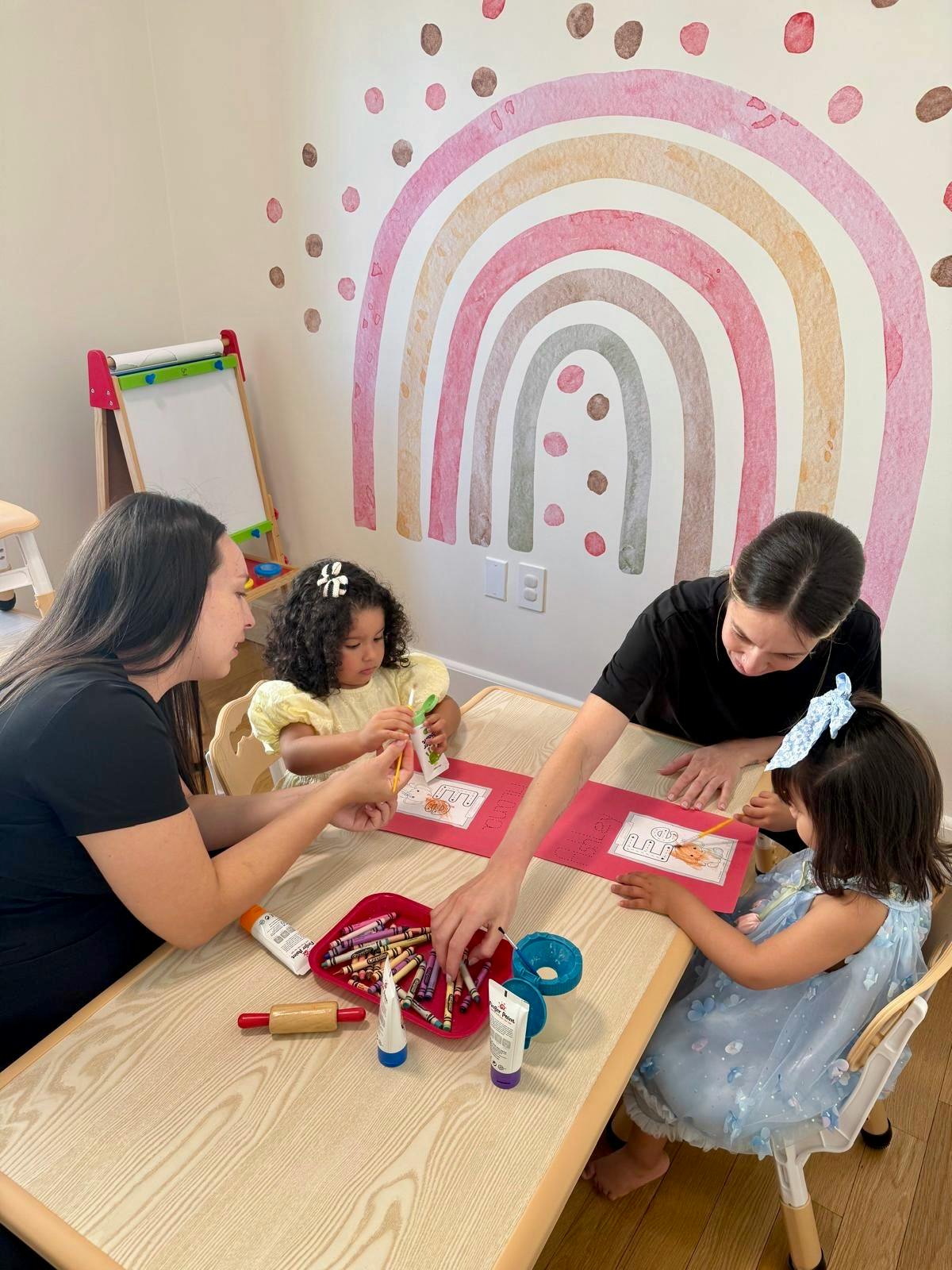 People coloring at a table with art supplies