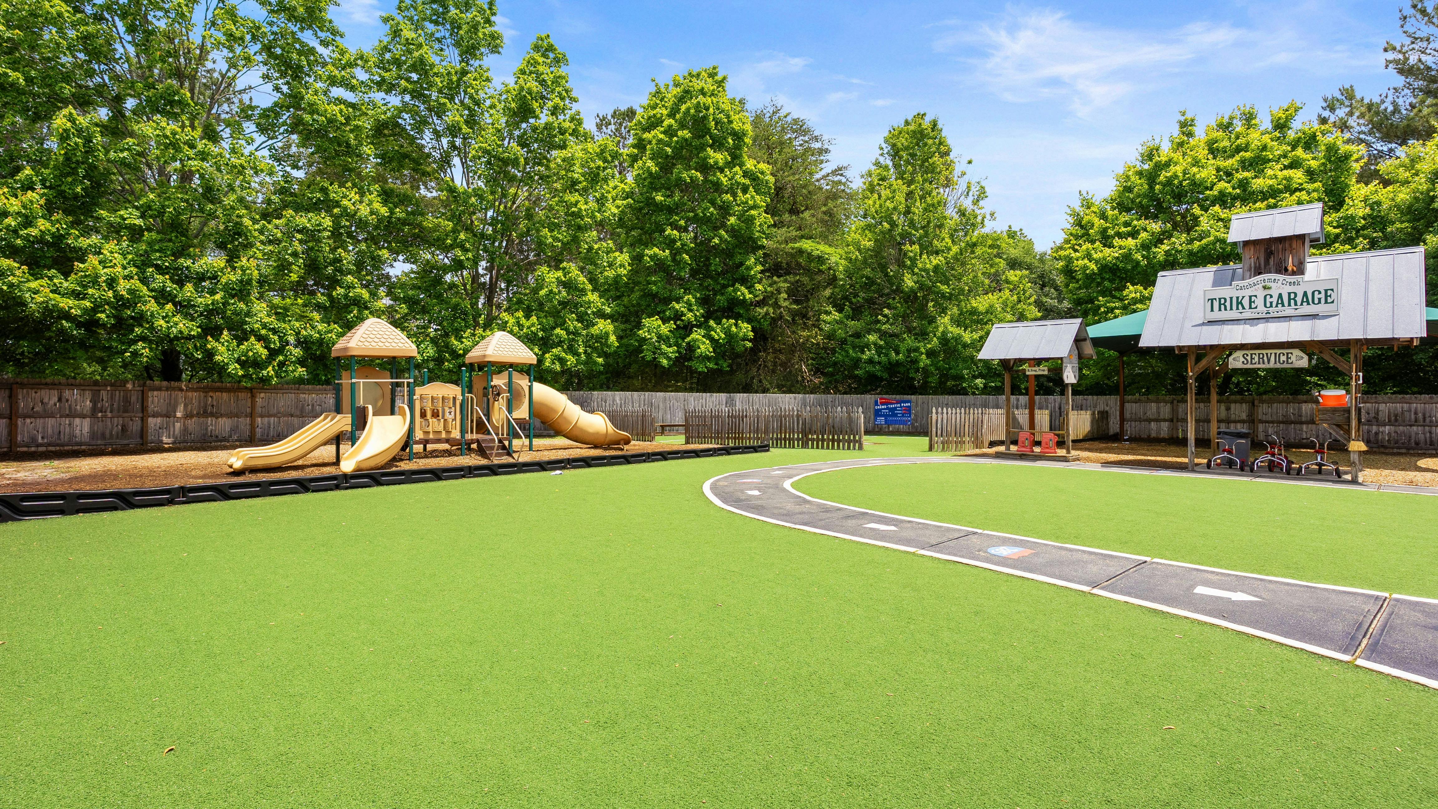 Playground with slides, track, and 'TRIKE GARAGE' sign