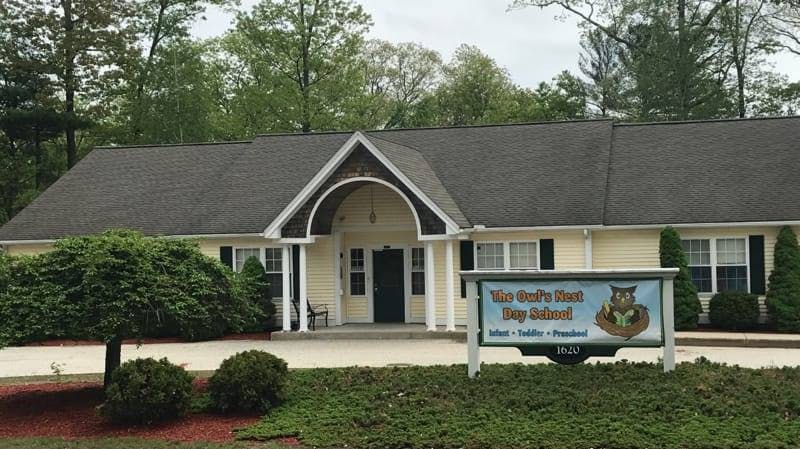 Building with a sign that reads "The Owl's Nest Day School"