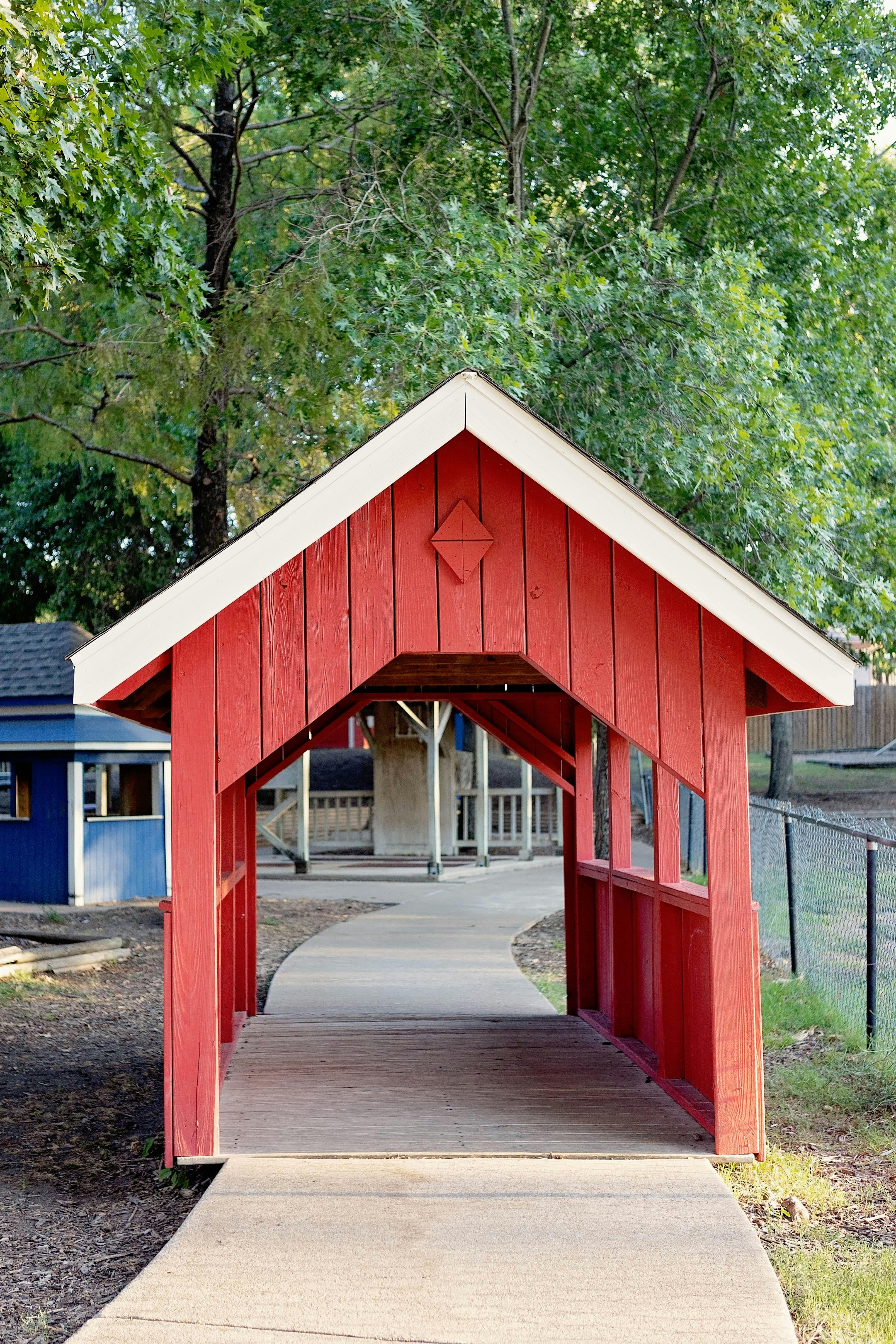 Red covered walkway leading to a playground