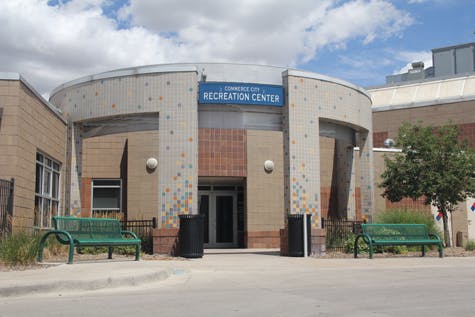 Recreation Center building entrance with benches and trash cans