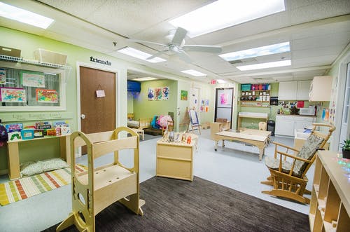 Empty classroom with various furniture and play areas