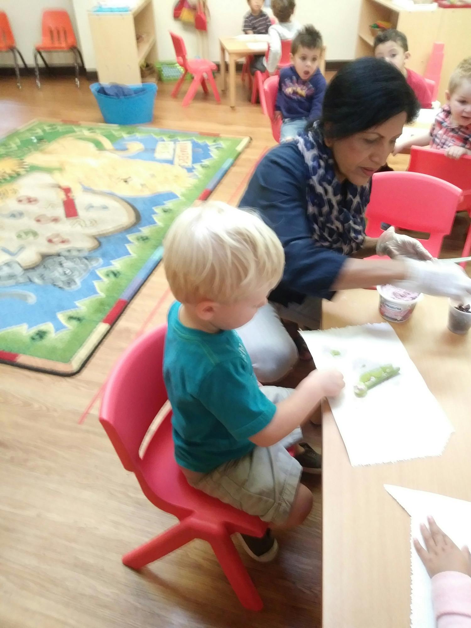 Adult and child at a table in a classroom
