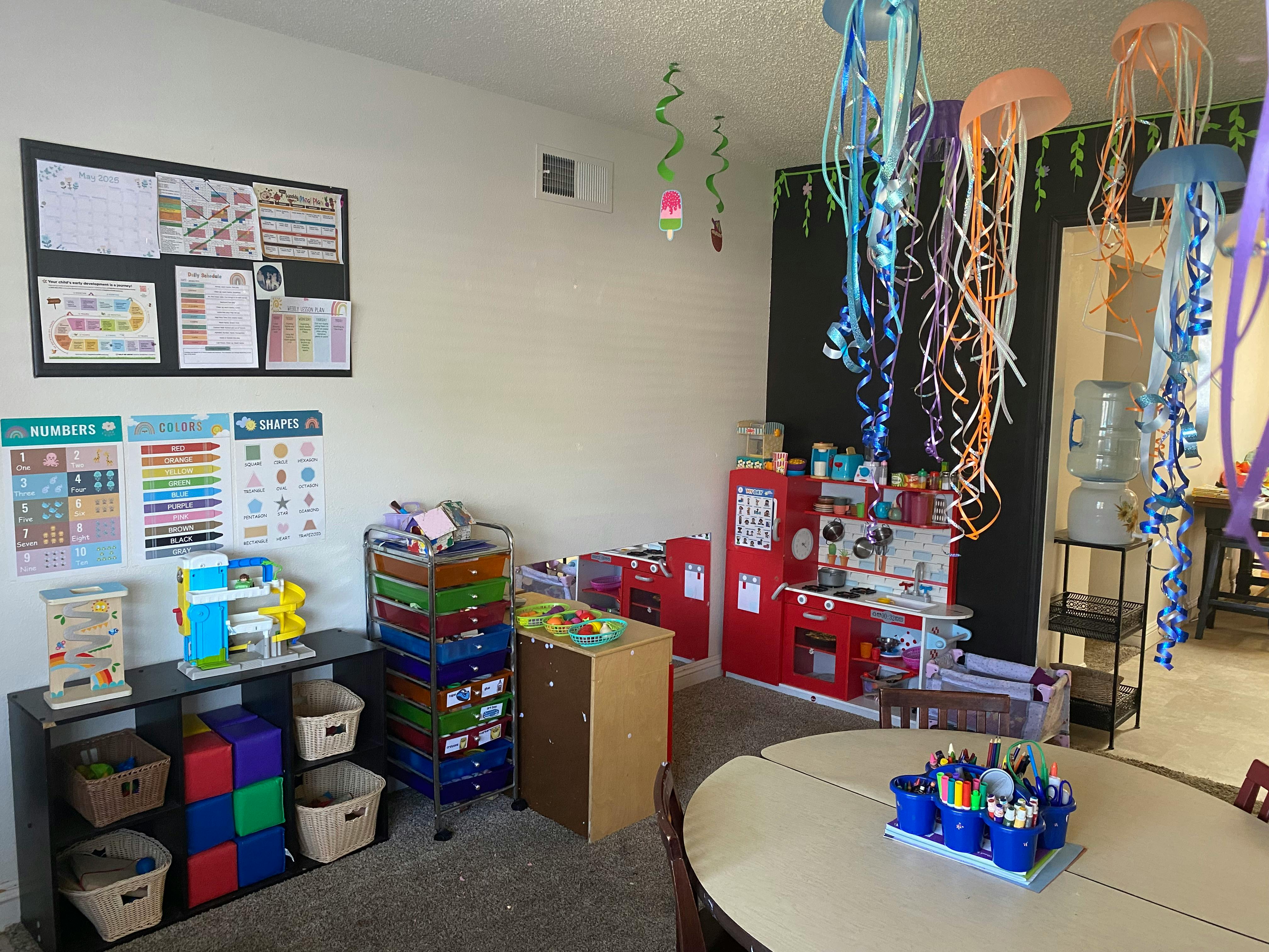 Classroom with play kitchen, storage, and jellyfish decorations