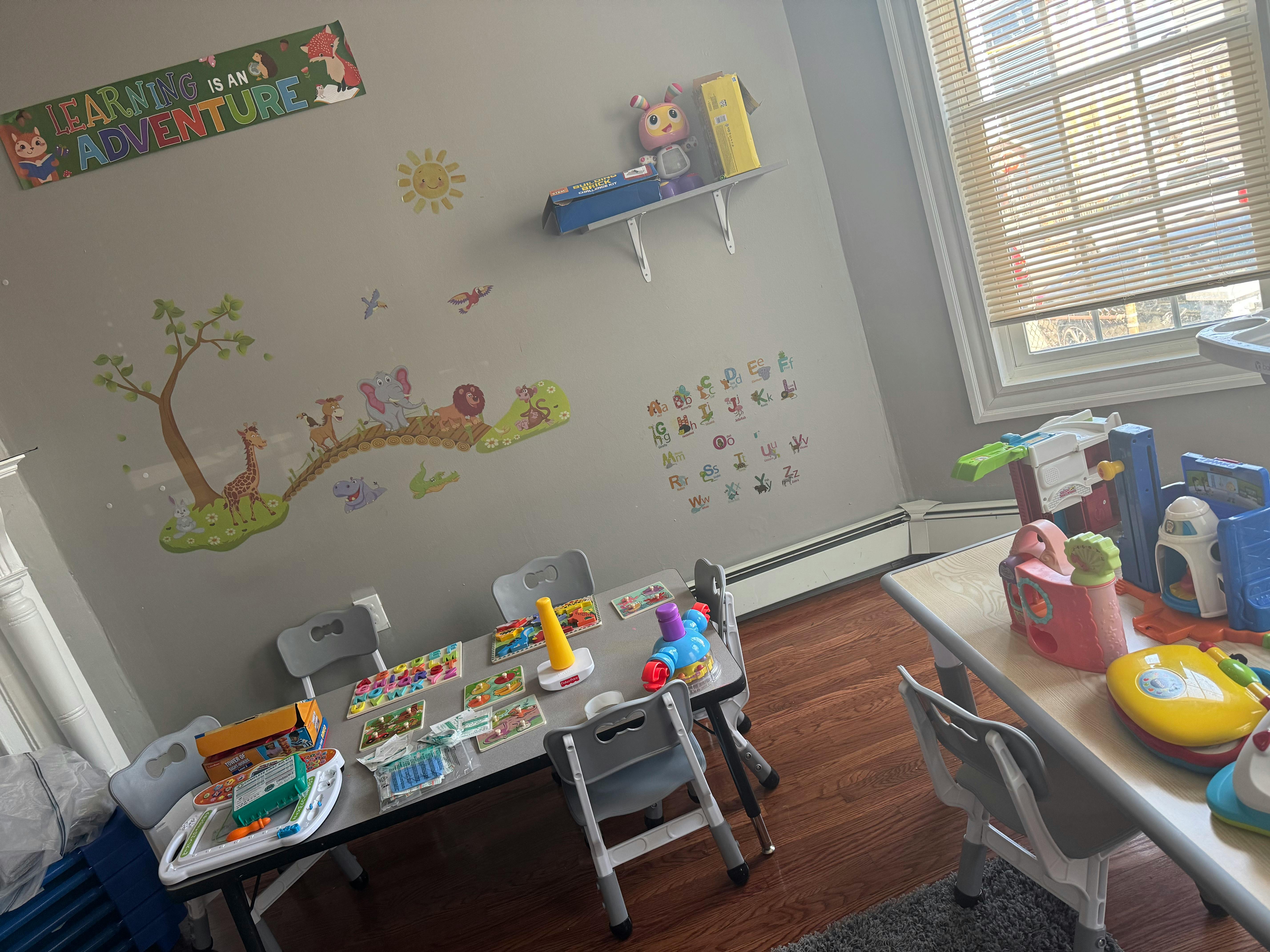 Children's play area with tables, chairs, and toys