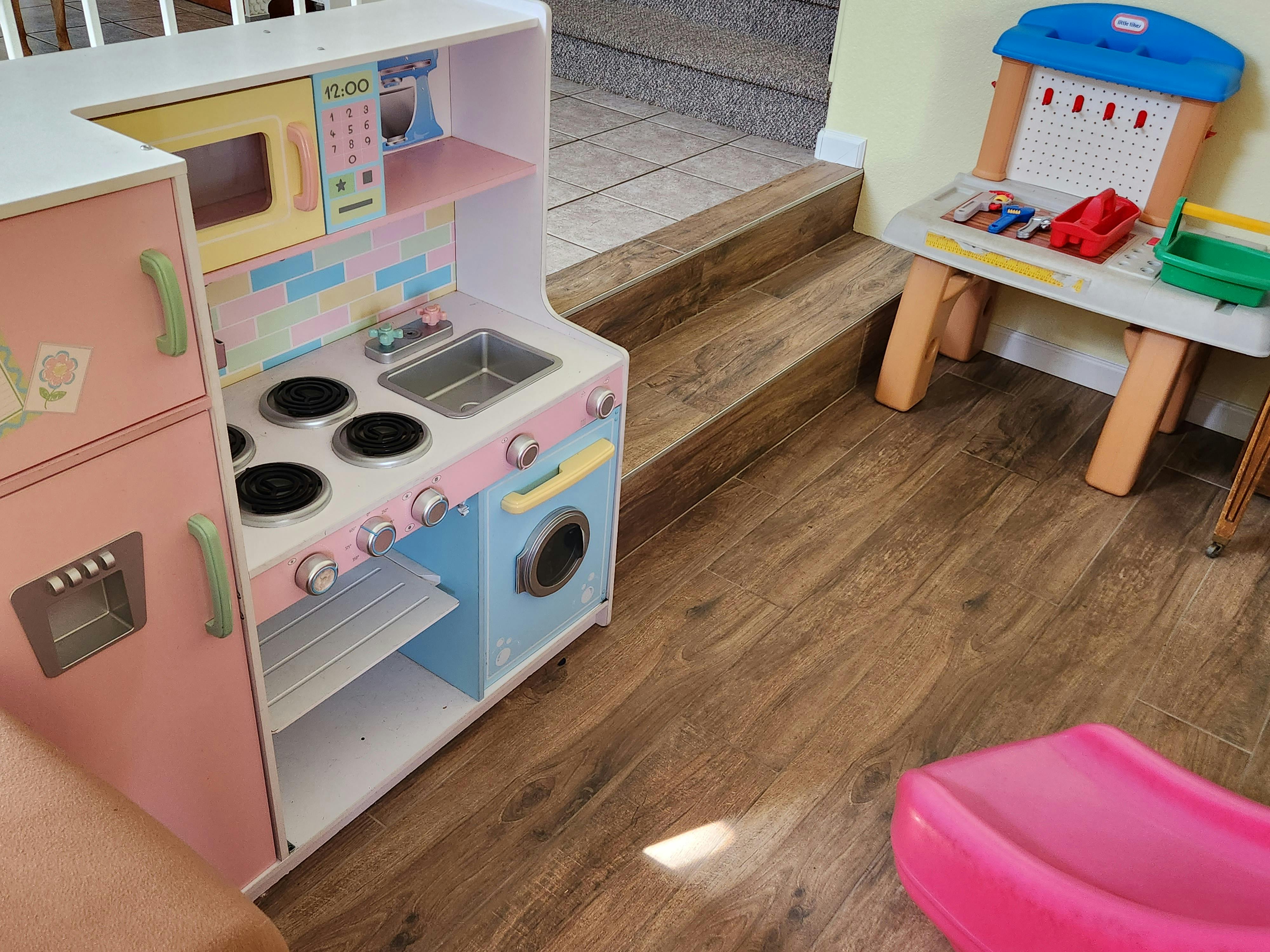 Toy kitchen set with refrigerator, stove, sink, and microwave