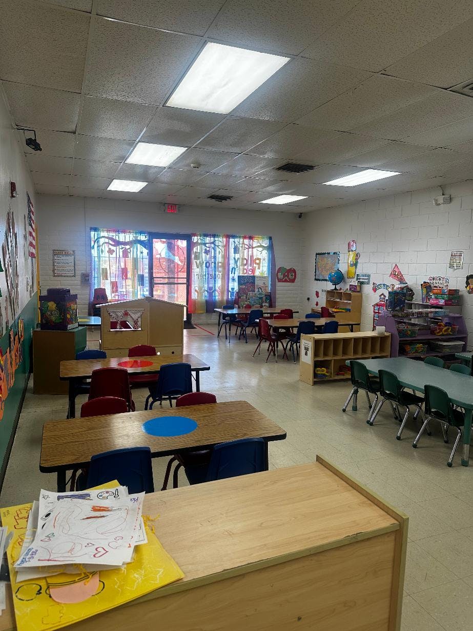 Empty classroom with small tables and chairs