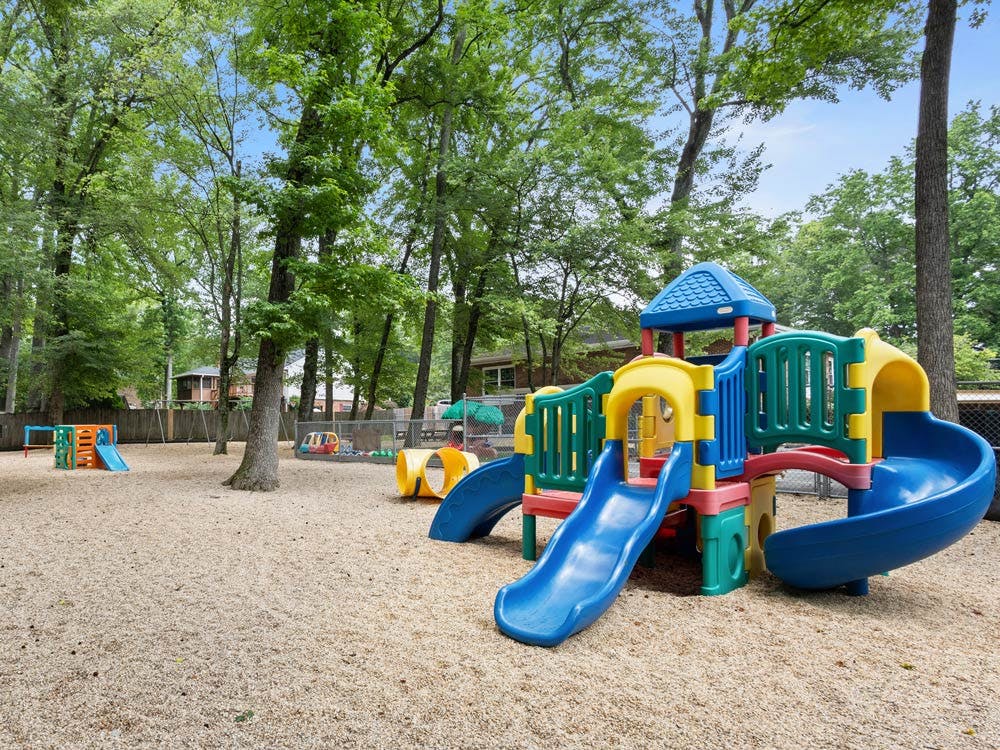 Colorful playground with slides and structures on wood chips