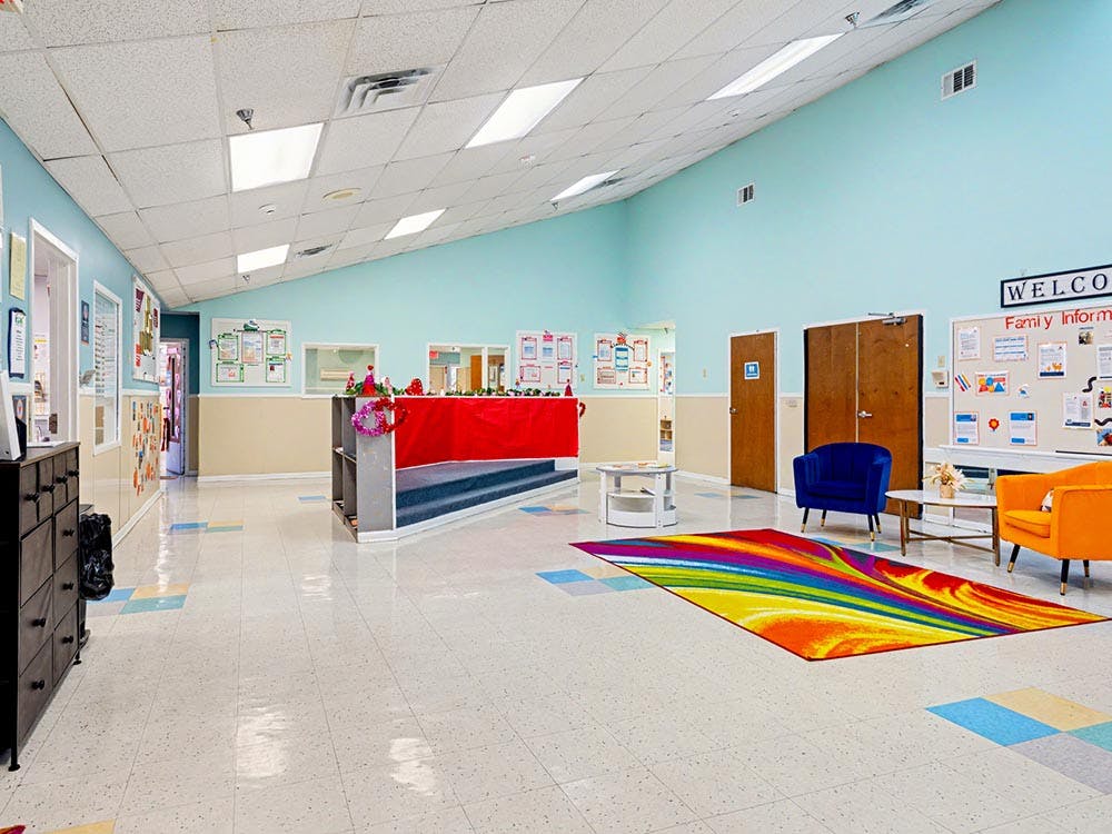 An empty indoor waiting area with light blue and beige walls