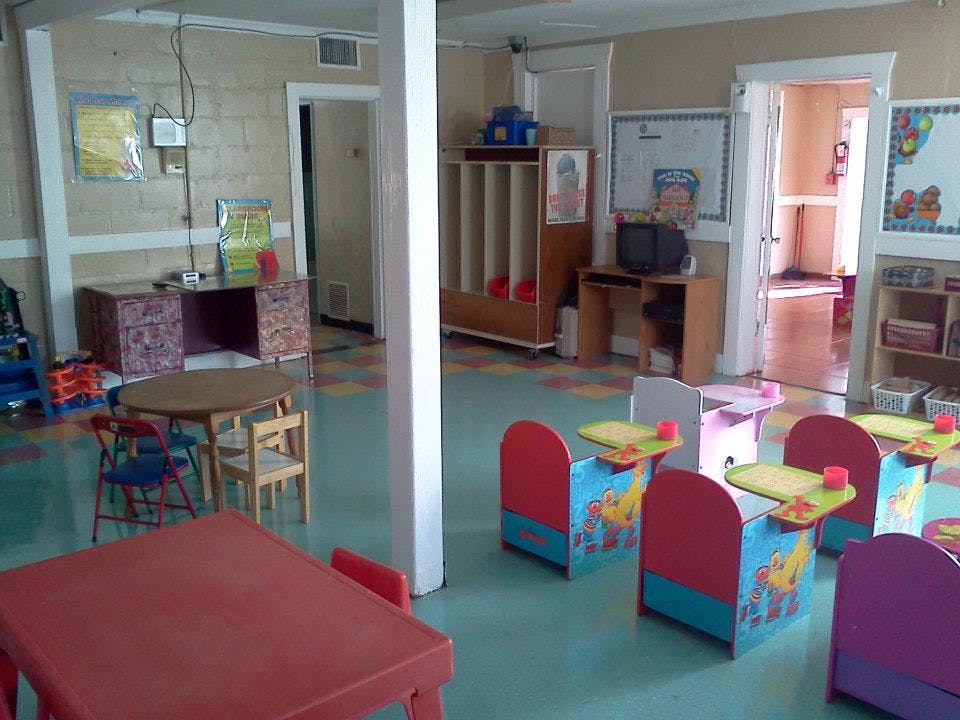 Empty classroom with small tables and chairs