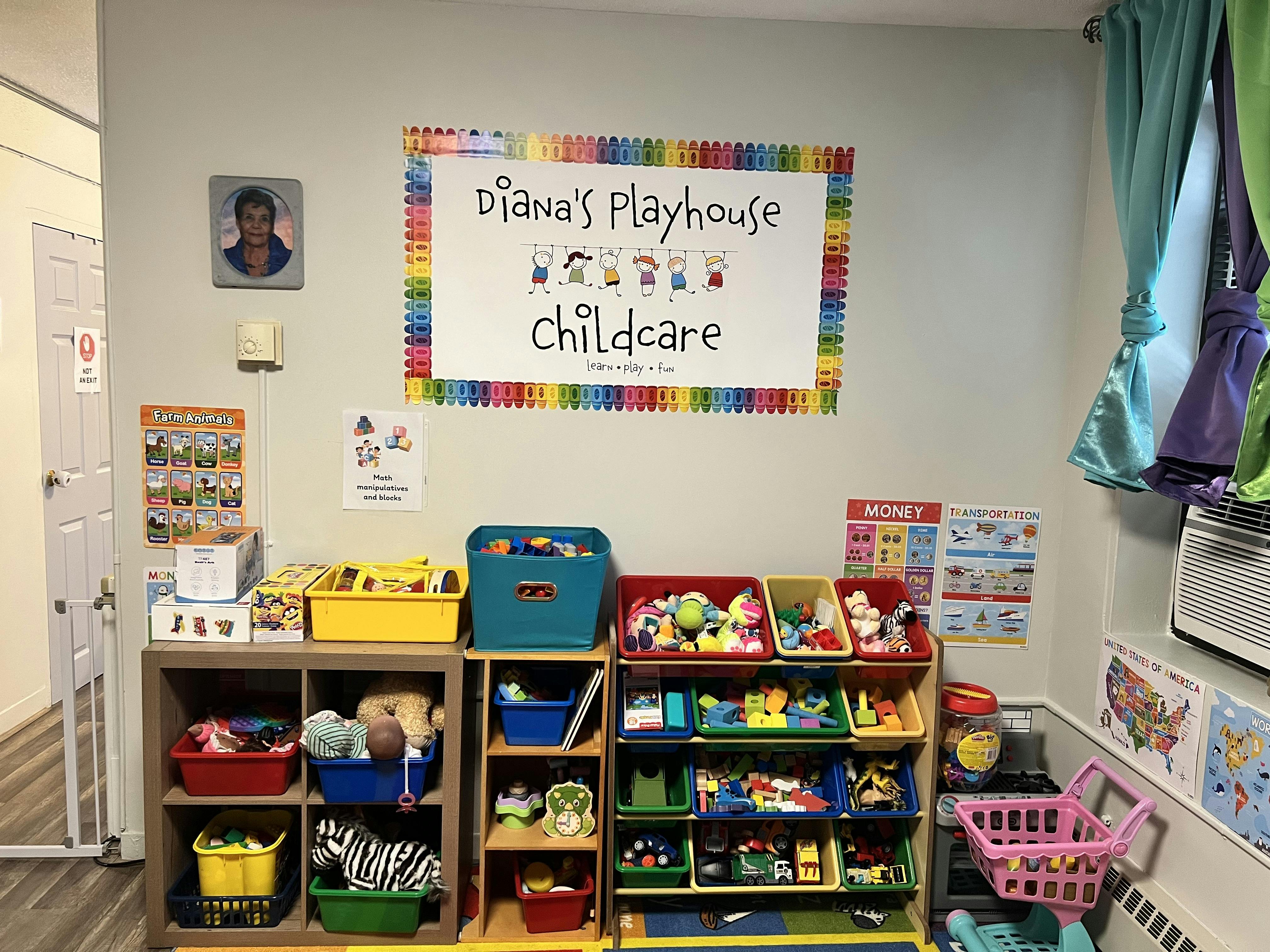 Childcare room with toy storage shelves and a sign that reads "Diana's Playhouse Childcare"