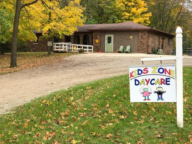 Kids Zone Daycare sign in front of a building