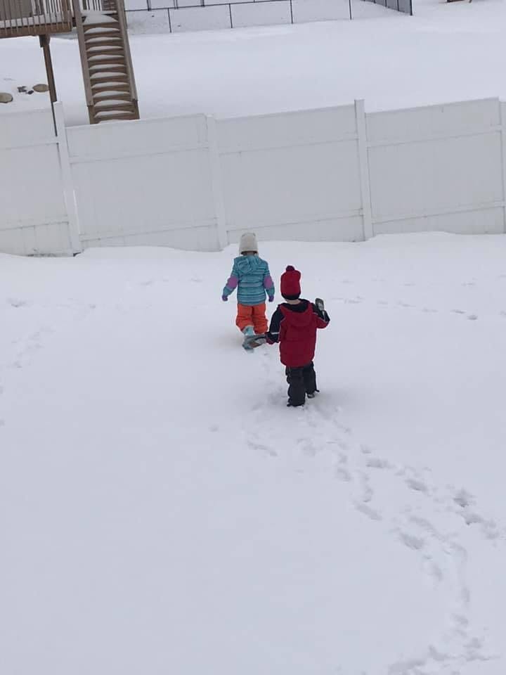 Two children walking in snow