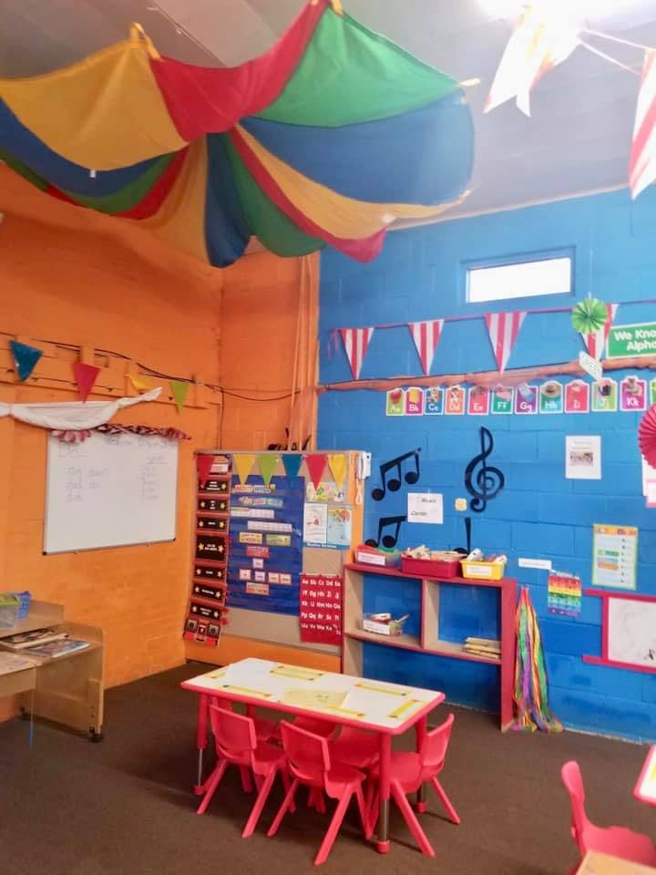 Colorful classroom with small tables and chairs