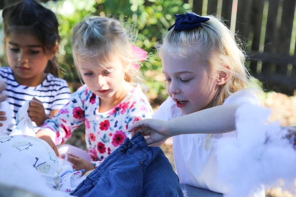 Three children looking at an object