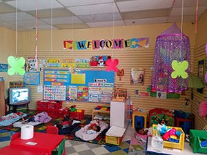 Classroom with a welcome sign and children's play area