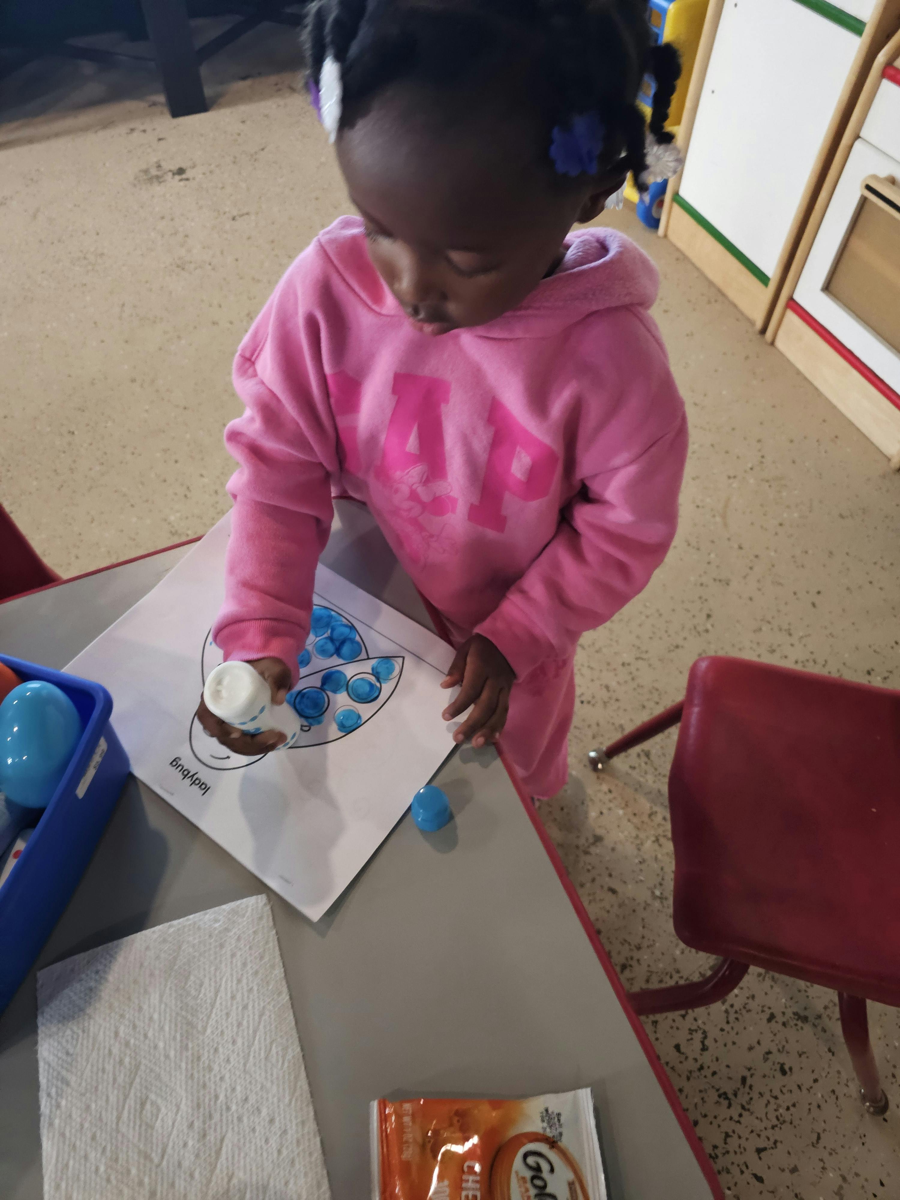 Child doing an art project at a table