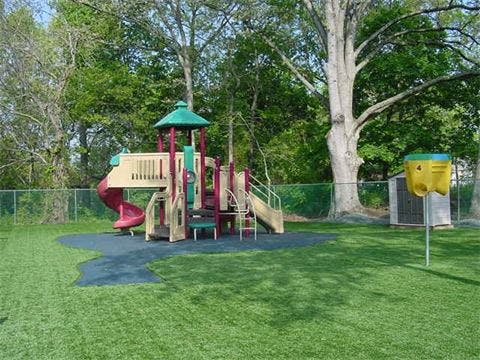 Playground with slides and climbing structures on artificial turf