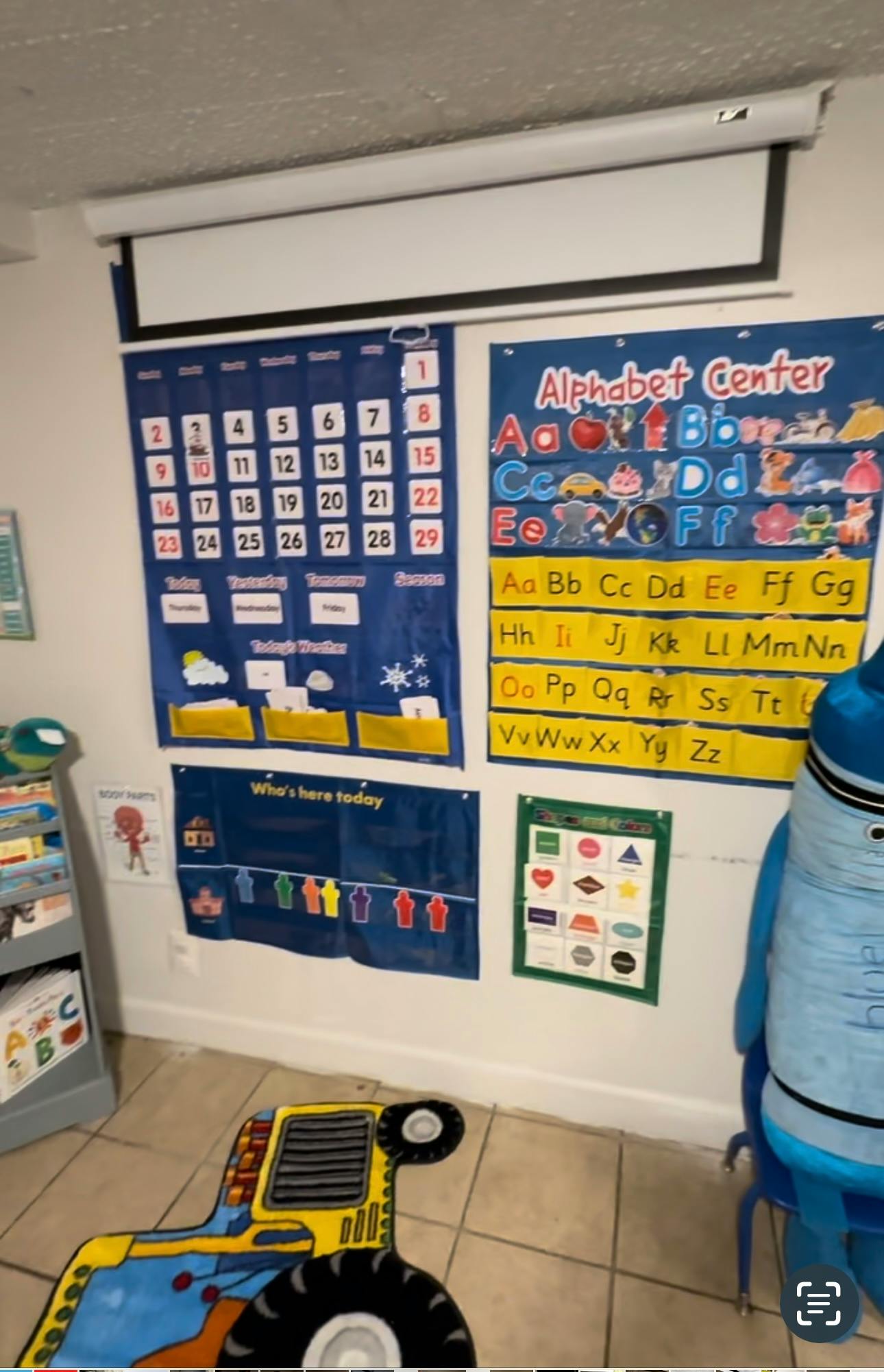 Classroom wall with calendar, alphabet chart, and other learning materials