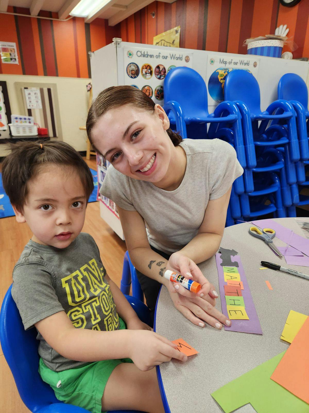 Person and child doing crafts at a table