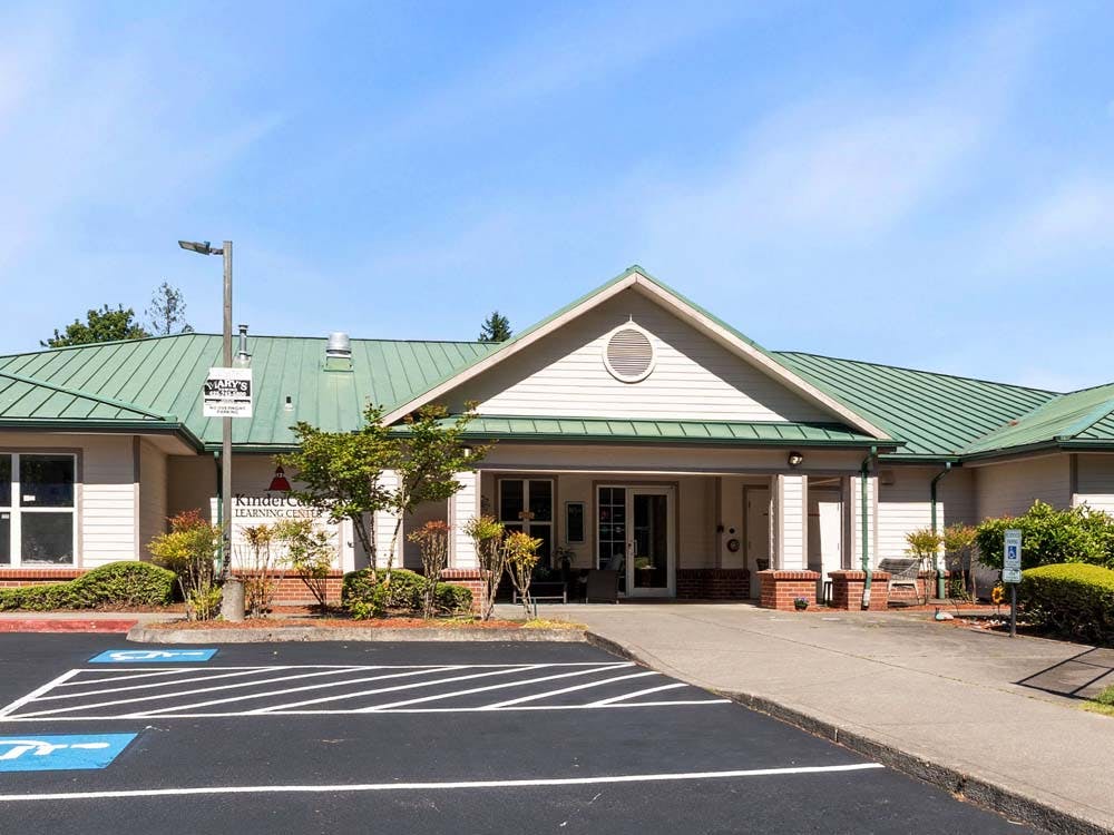 KinderCare Learning Center building with green roof and parking lot