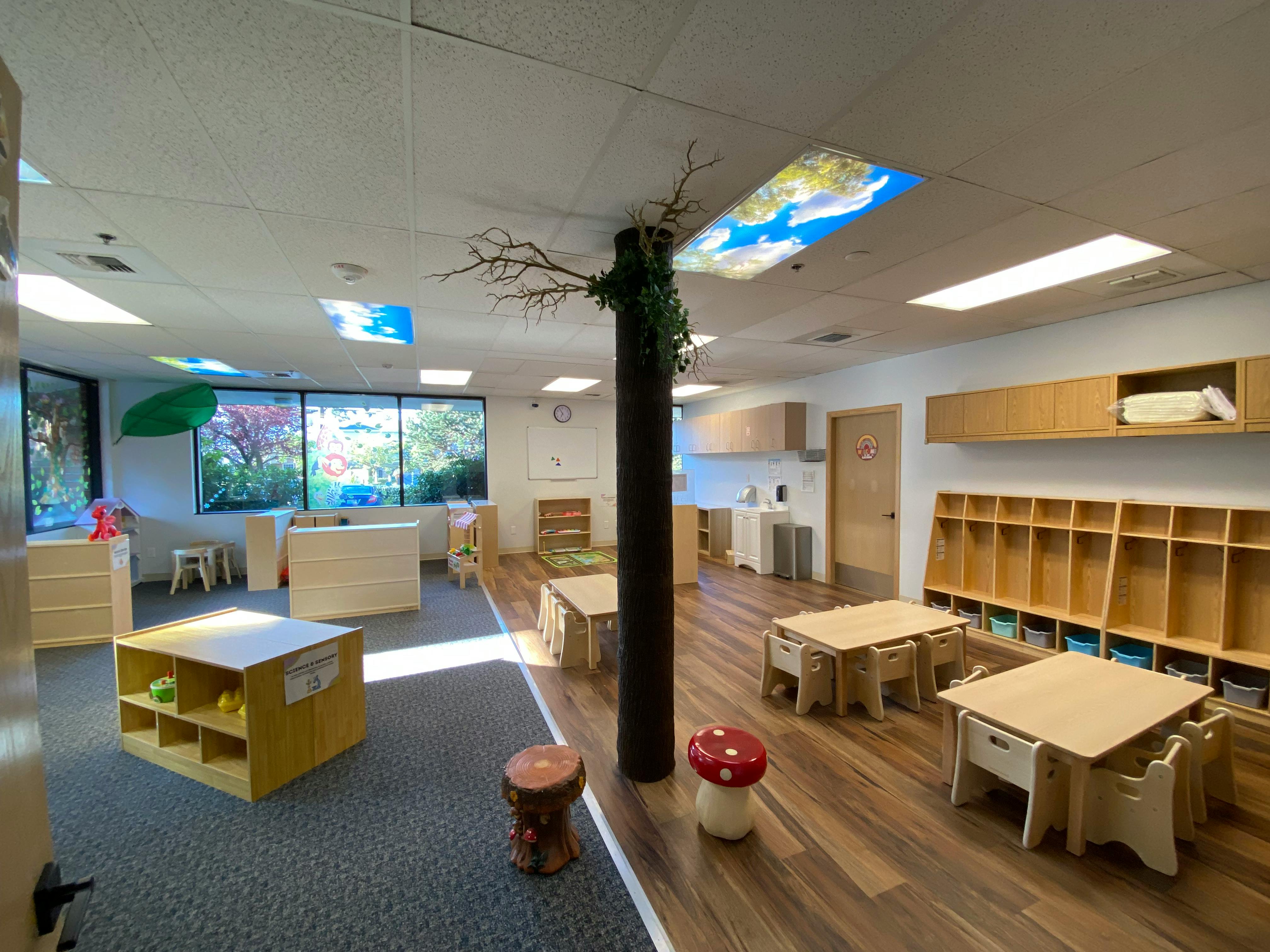 Classroom with child-sized tables and chairs upside down on the ceiling