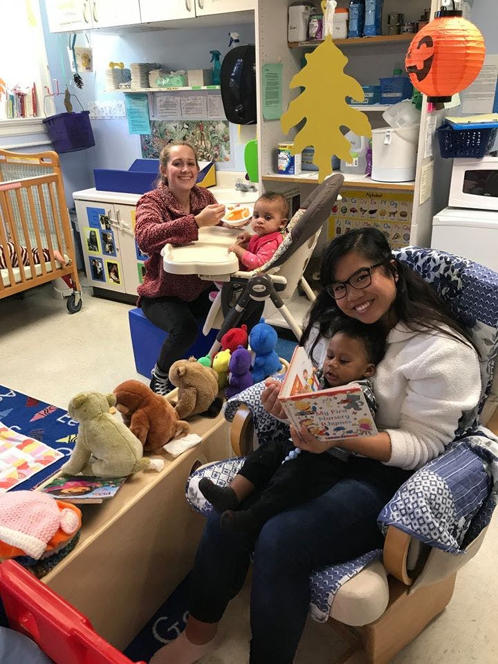 Two adults with two children in a classroom