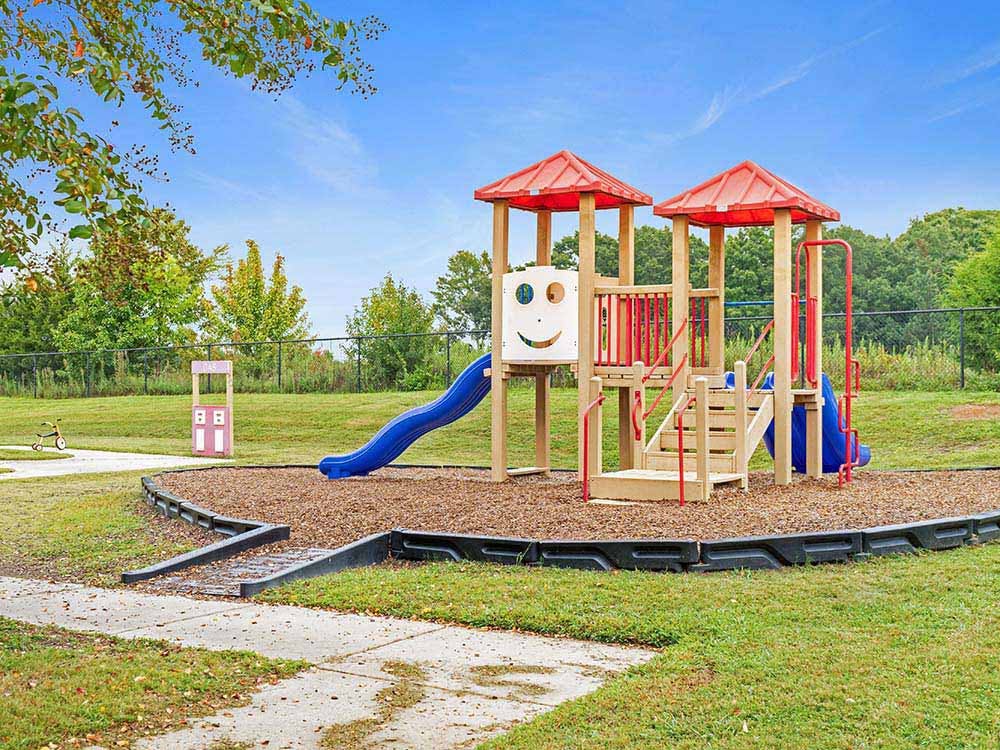 A colorful playground with slides and steps on a sunny day
