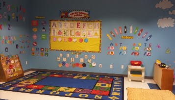 Classroom with alphabet chart and colorful rug