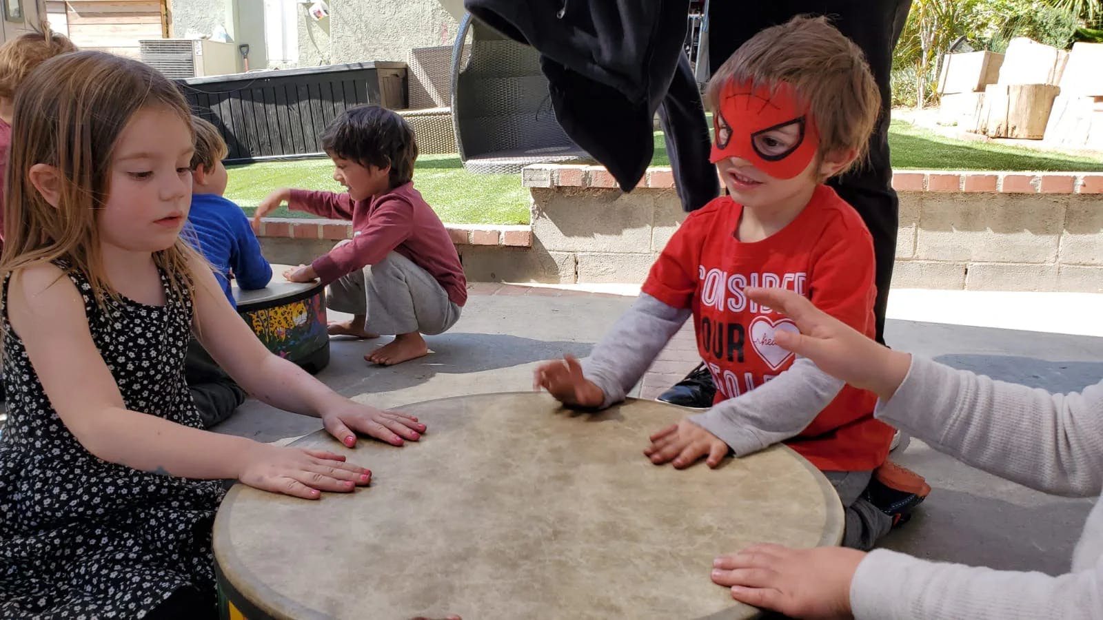 Children playing drums outdoors