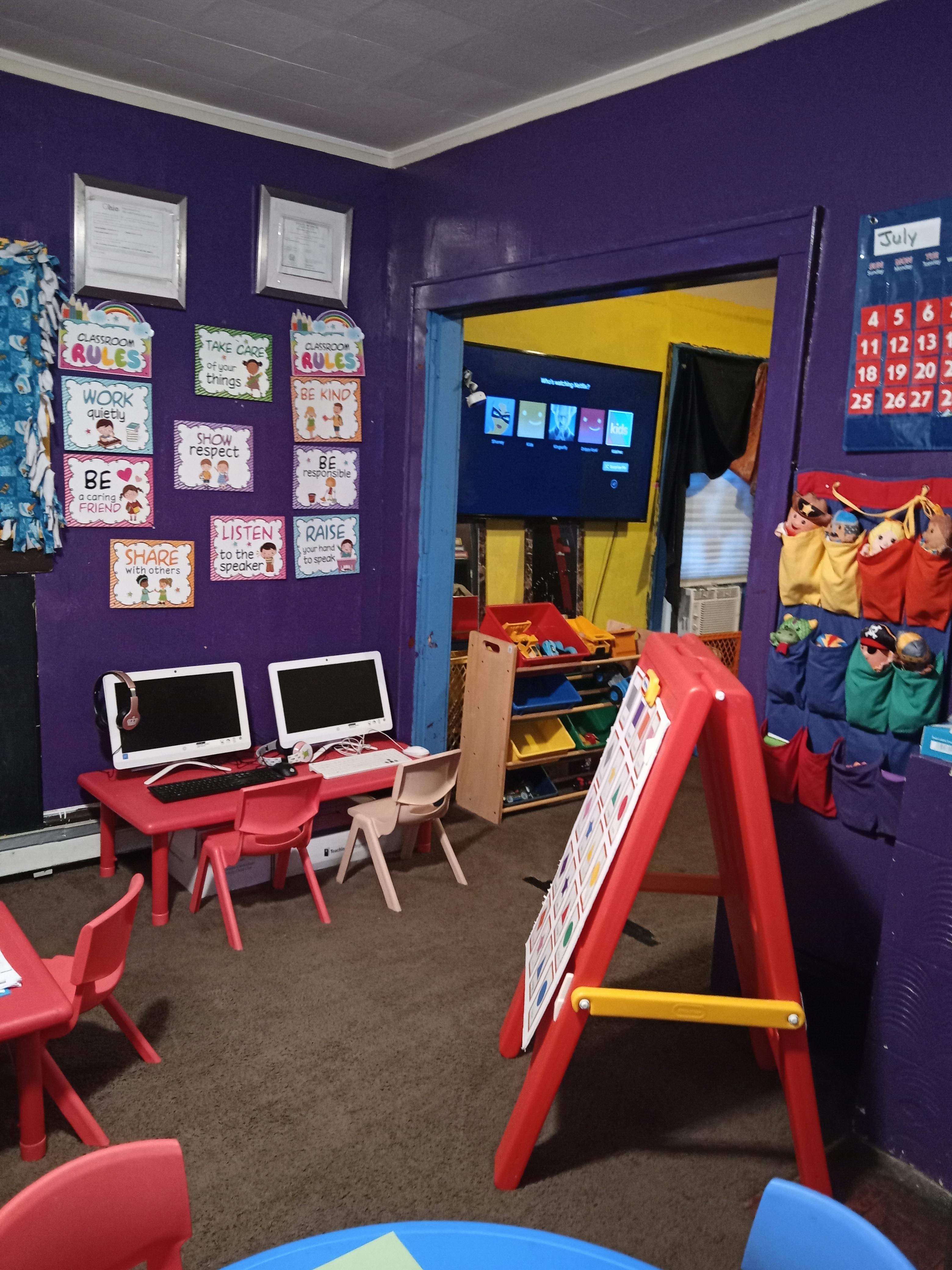Classroom with computers, chairs, and a calendar