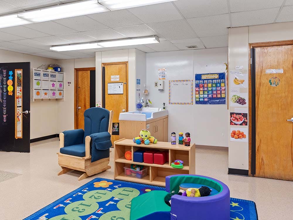 Classroom with a rocking chair, changing table, and play area